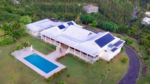 A large house with a swimming pool, multiple rooms, and a covered outdoor area. - Luxury 4BR Villa with Pool & Harbor Views (St. Thomas)