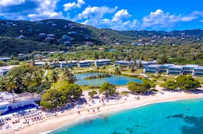 A resort with a beach, a pool, and a mountainous backdrop. - 1 BR condo on Sapphire Beach! Sleeps 6! (St. Thomas)