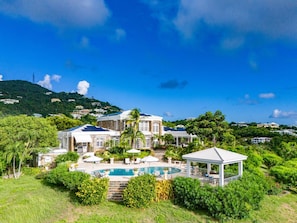A large house with a swimming pool, surrounded by lush greenery and hills. - 2BR New remodel w/Restoration Hardware & Tennis (Charlotte Amalie East)