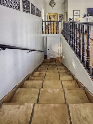 A staircase with a handrail, leading to a second-floor landing with a railing. - 4BR Waterfront - 5 Minutes To Magen`s (St. Thomas)