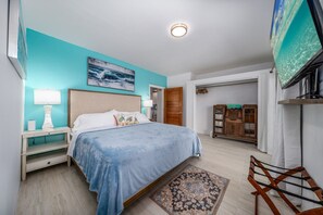 A bedroom with a bed, nightstands, a TV, and a wardrobe. - Centrally located 3br with pool, incredible harbor views! (St. Thomas)