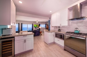 A modern kitchen with white cabinets, a built-in oven, and a stove. - Centrally located 7br with pool, 3 kitchens, pool and lots of space! (St. Thomas)