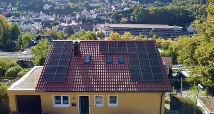 Fully furnished vacation rental with a parking space and a wall-mounted charging station right outside the door.