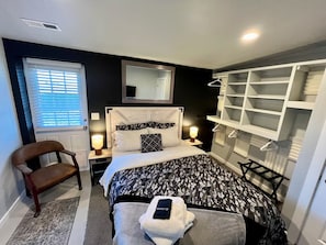 A bedroom with a bed, bedside tables, a chair, a walk-in closet, and a window with blinds. - 12 BDR ID Retreat, Hot Tub, beds for 37+, Events (Nampa)