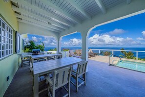 A covered outdoor area with a pool, lounge chairs, and a table. - 5BR Villa w/pool in peaceful residential neighborhood (Charlotte Amalie West)
