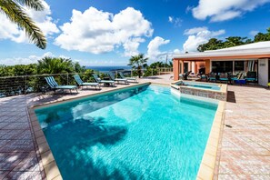 A clear blue pool with lounge chairs and a view of the ocean. - Amazing harbor views & central, gated location!! 5 en-suite baths! (St. Thomas)