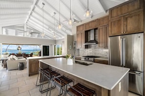 A spacious kitchen with a large island, stainless steel appliances, and a view of the ocean. - 4BR Villa, Private Pool, 360° Ocean Views (St. Thomas)