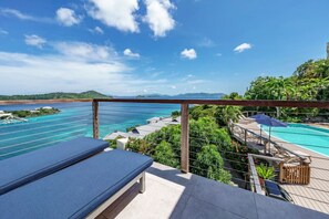 A poolside area with a view of the ocean and a distant island. - 5BR Private Villa, Huge Pool, Ocean Views (St. Thomas)