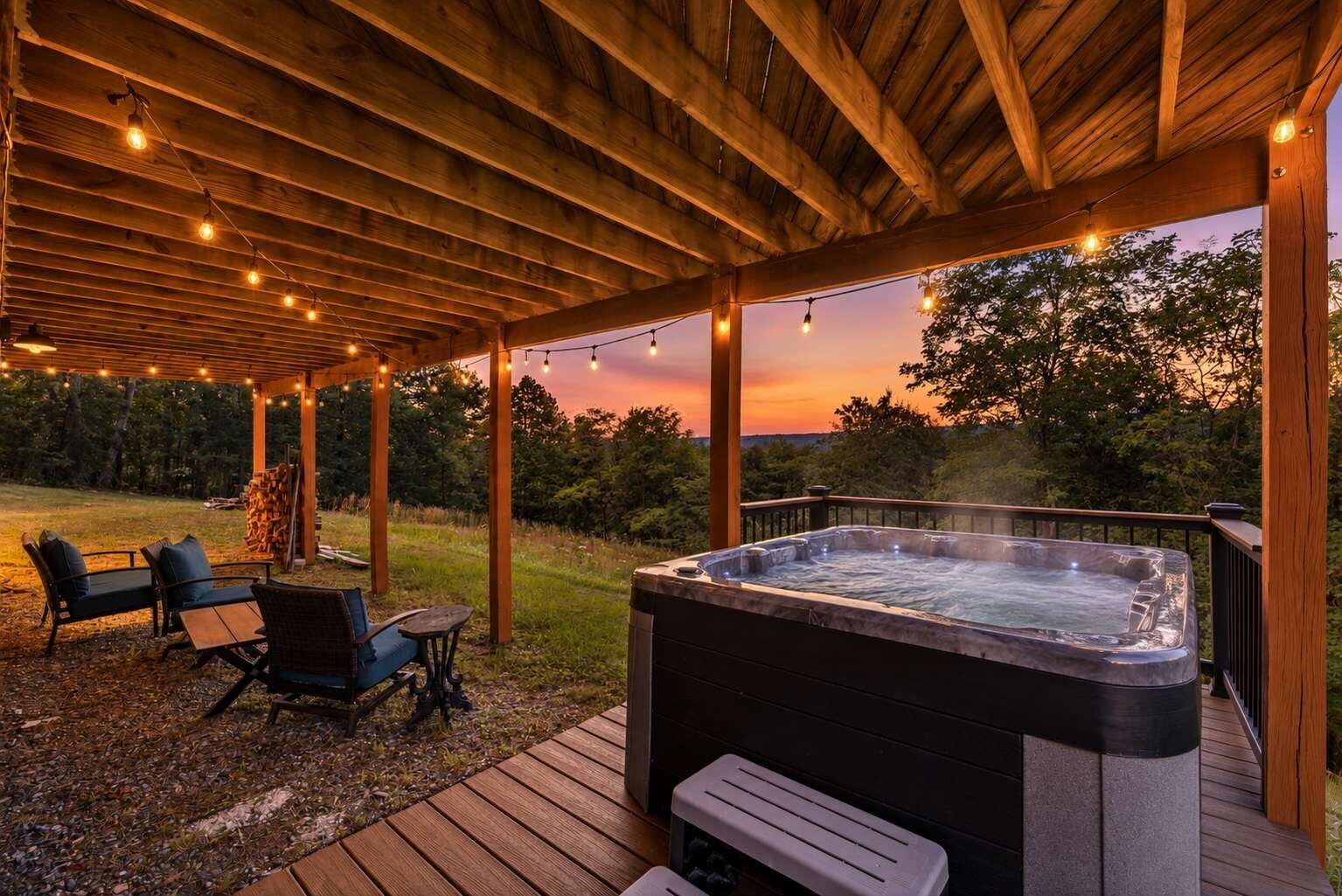 A wooden deck with a hot tub, outdoor seating, and string lights.