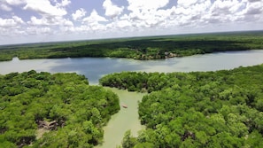 A river surrounded by dense green forest. - Eco Hotel Leào de Judá - All Inclusive (Curuçá)