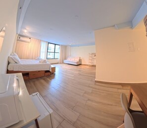A modern hotel room with a large bed, a smaller bed, a desk, and a chair. - Carió, studio apartment in Copacabana, a few steps from the beach and Leme. (Rio de Janeiro)