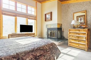 A bedroom with a bed, a fireplace, a television, and a dresser. - Beautiful 3Bd 4Bt townhome in Breckenridge perfect for mountain sports getaways (Breckenridge)