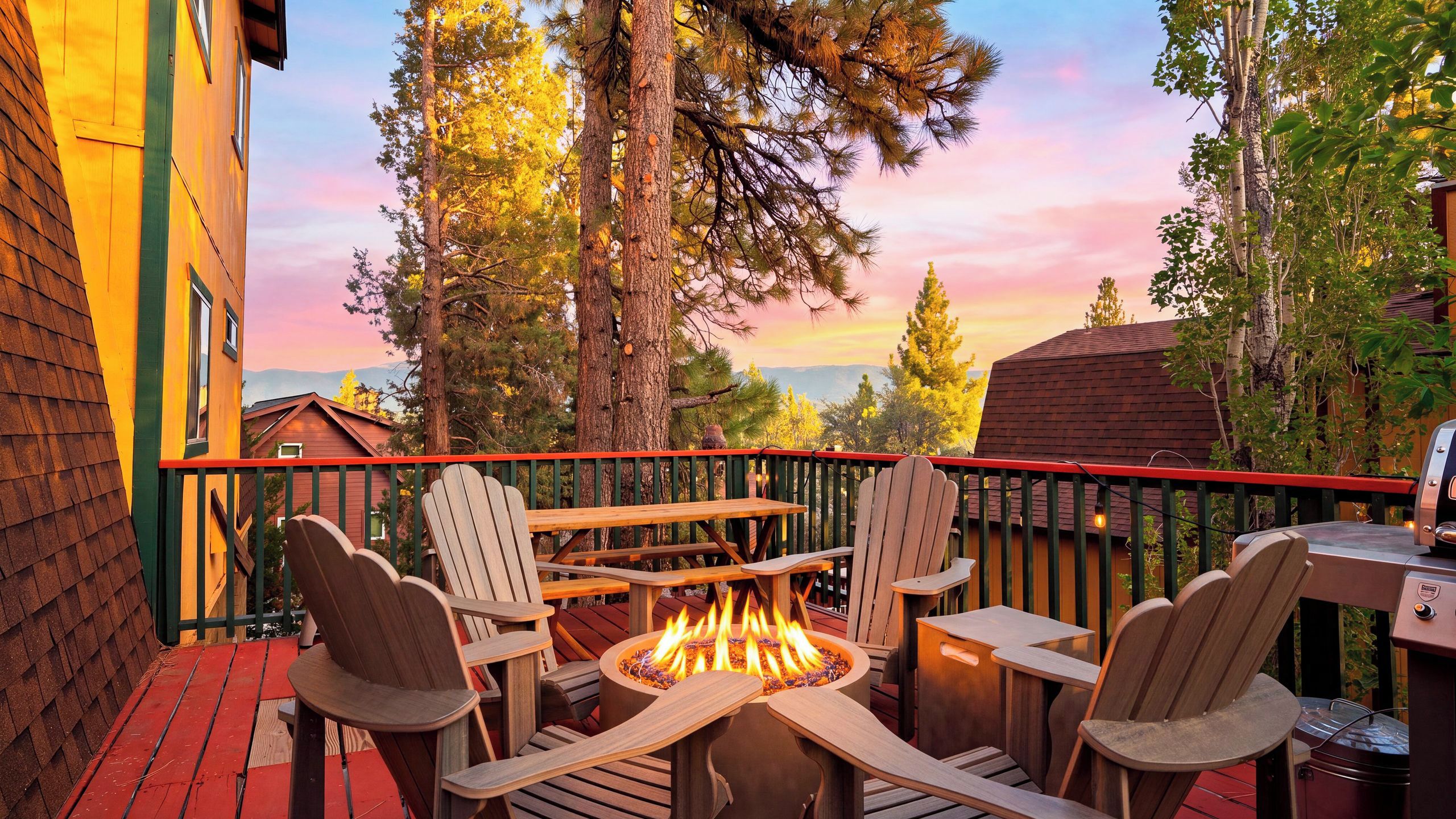 A deck with outdoor seating and a fire pit.