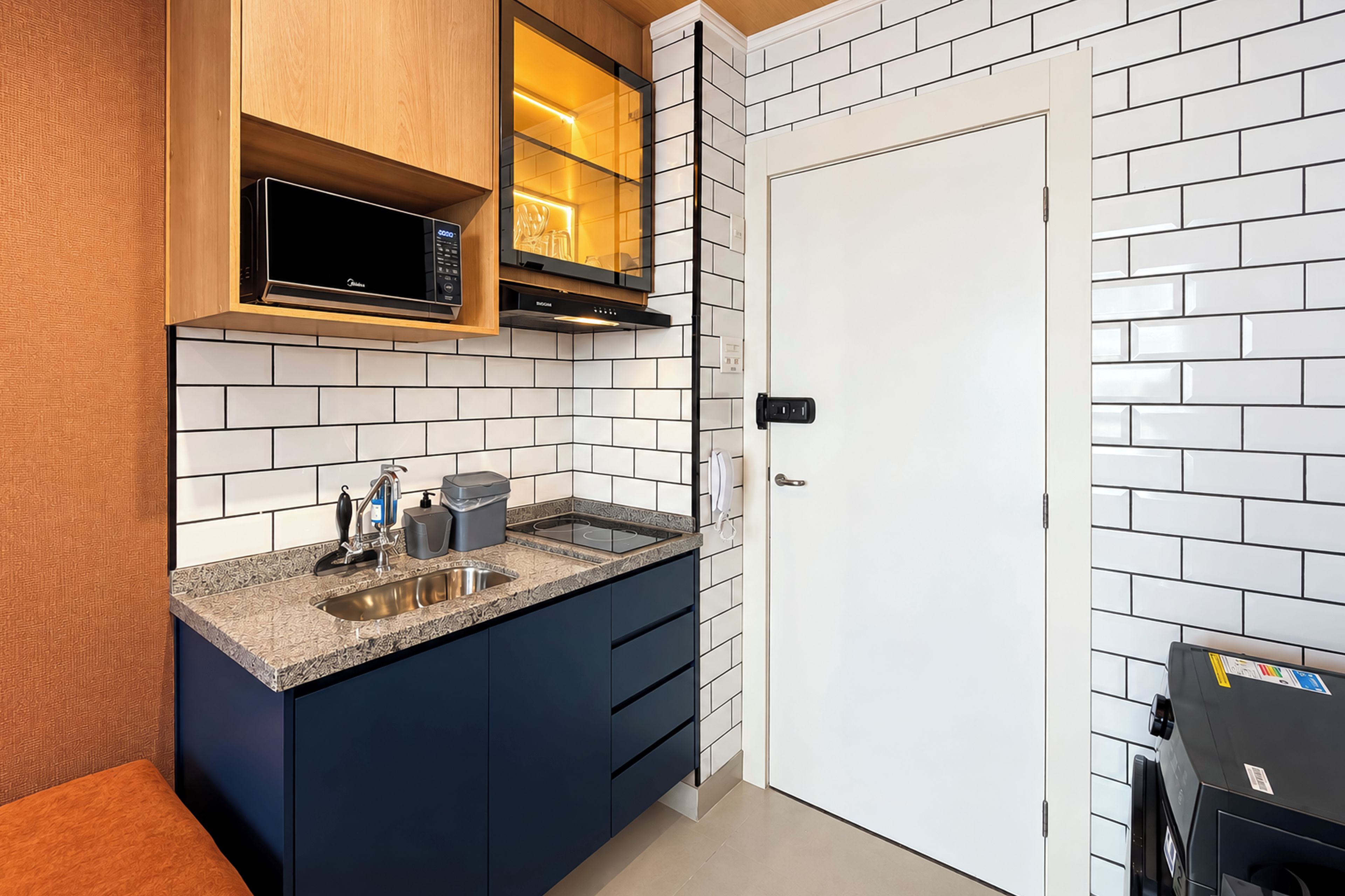 A modern kitchen with a built-in microwave, a stove, and a sink.