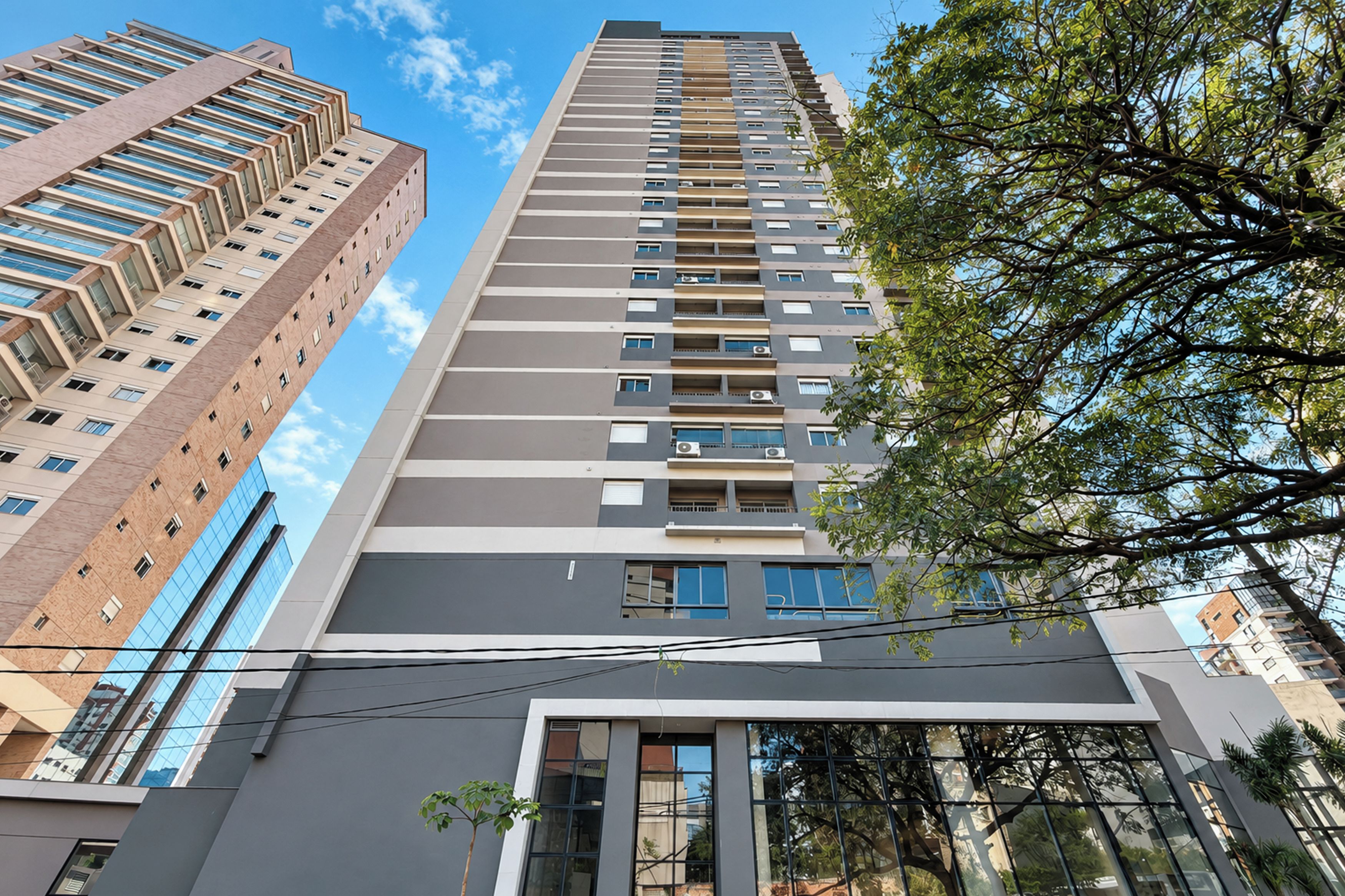A high-rise building with multiple floors, large windows, and a modern architectural design.