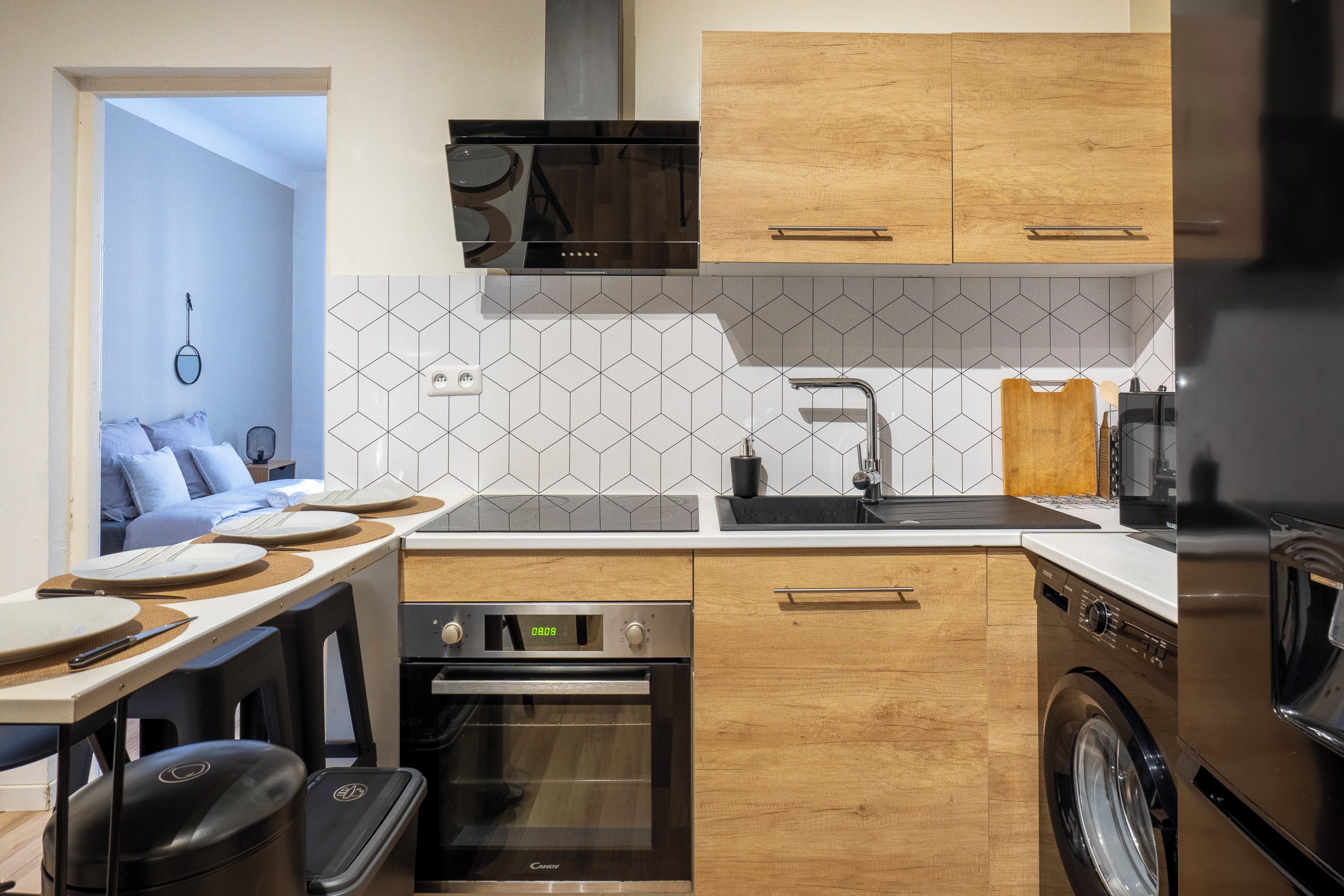 A compact kitchen with a microwave, oven, and dishwasher.
