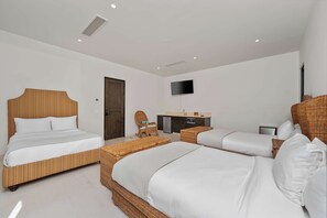 A hotel room with two beds, a TV, a kitchenette, and a door. - Beautiful House at Coronado Quivira Golf Course (Cabo San Lucas)