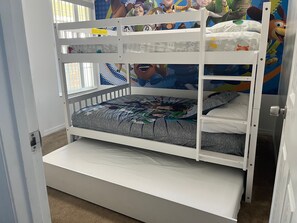 A bunk bed with a lower bunk and a mattress with a colorful design. - Family-Friendly 3BR/2BA Condo Minutes from Disney with Pool & Gym (Kissimmee)