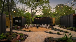 An outdoor patio with seating and string lights.