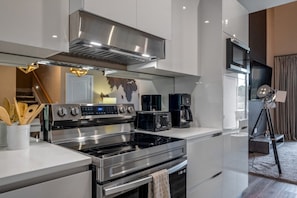 A modern kitchen with stainless steel appliances, a built-in oven, and a microwave. - Family Getaway Near Disney (Kissimmee)