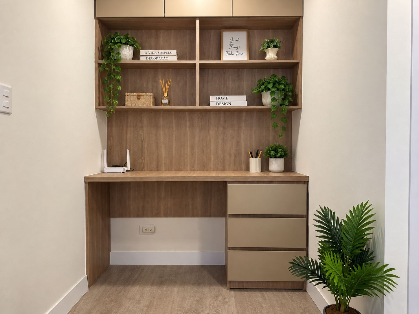 A modern desk with a wooden finish, a shelf with decorative items, and a potted plant.