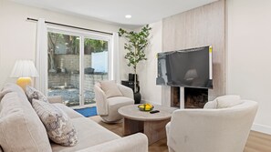 A modern living room with a sofa, armchairs, a coffee table, and a flat-screen TV. - Modern 5BR 4BA Prime Location Entire House (Rowland Heights)