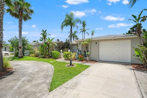 A residential driveway with a curved path leading to a garage. - 3BR Screened Heated Saltwater Pool • BBQ (Port Richey)