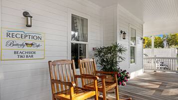A reception area with wooden rocking chairs and a potted plant.
