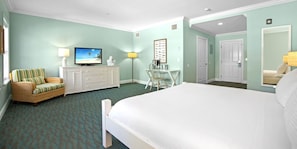 A hotel room with a bed, a television, a desk, and a chair.