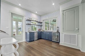 A modern kitchen with blue cabinets, a white countertop, and a built-in oven. - Elegant Beachfront Retreat with Gorgeous Pool in Waveland, MS (Waveland)