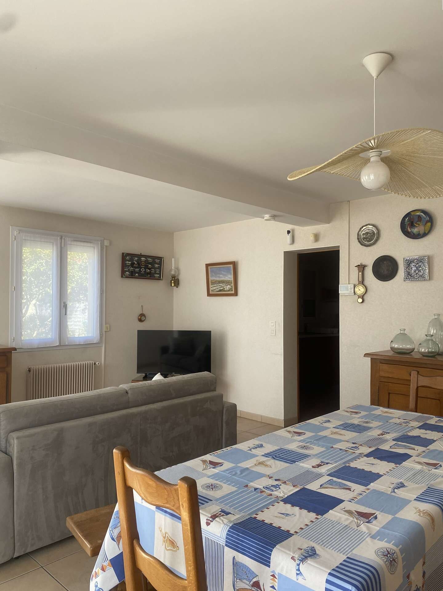 Una camera da letto con un letto, una televisione, un divano e una ventola a soffitto.