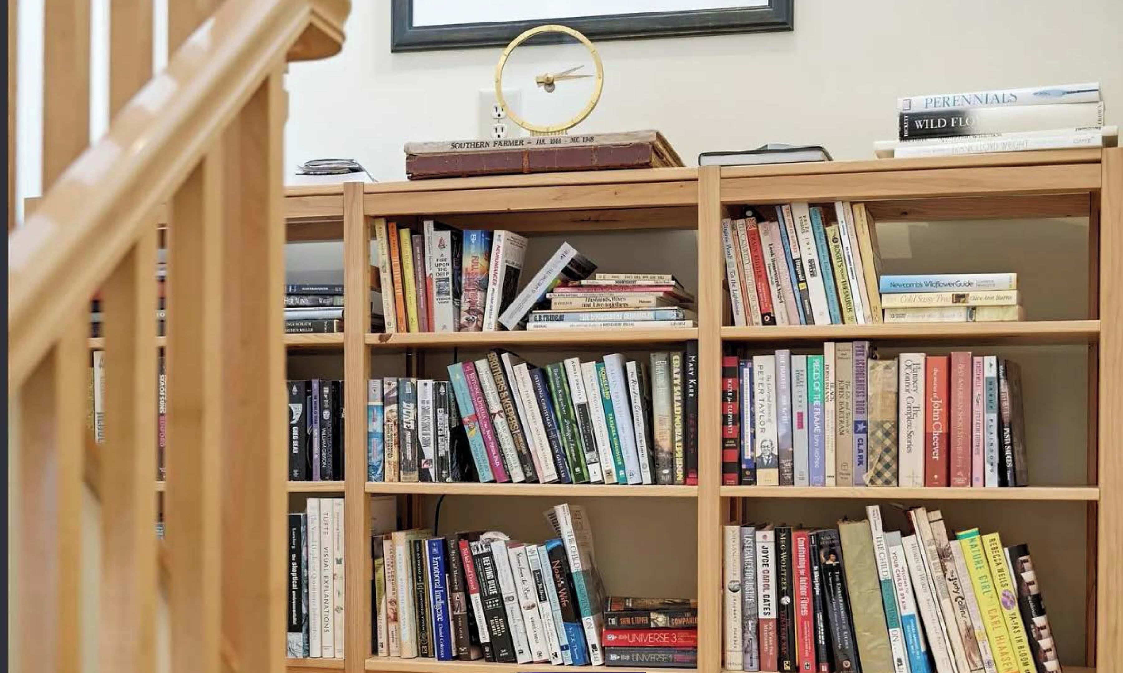 A library with multiple wooden bookshelves filled with books.