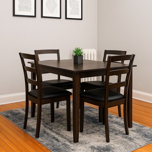 A dining table with four chairs, a small potted plant, and framed artwork on the wall. - 2BR Steps from Wrigley Field (Chicago)