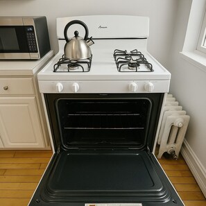 A kitchen with a stove, oven, and microwave. - Feel at Home in our 2BR Apt (Chicago)