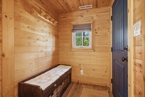 A wooden cabin room with a bench, a small window, and a door. - Big Pine House! Hot Tub + Dog Friendly + Fire Pit (South Lake Tahoe)