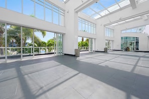 A spacious indoor area with large windows and a flat floor. - Oceanview Studio at Fontainebleau Miami Beach with Balcony (Miami Beach)