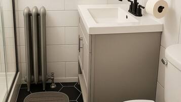 A compact bathroom with a toilet, sink, and window.