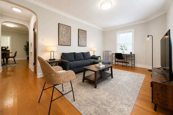 A modern living room with a sofa, coffee table, and a television.
