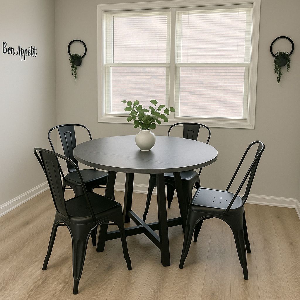 A dining area with a round table, black chairs, a white vase with a plant, and two wall-mounted planters.