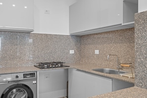 A compact kitchen with granite countertops, a built-in dishwasher, and a stainless steel sink. - Maraya Pool Front Studio El Gouna (El Gouna)