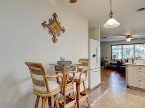 A kitchen with a dining area, a refrigerator, and a ceiling fan. - Tremendous house with AC in sunny Vero Beach (Vero Beach)