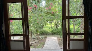 A room with an open door leading to a garden.