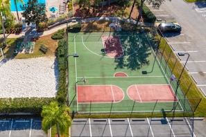An aerial view of a basketball court with a surrounding fence, a parking lot, and a pool area. - Windsor Palms 3 Bed Condo In Gated Resort 3 Bedroom Condo (Kissimmee)