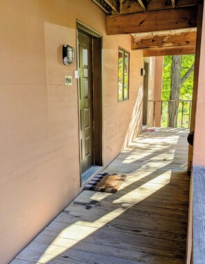 A wooden covered walkway with a door marked '790' leading to a building. - Welcome to Bellaire Base Camp at Shanty Creek Resorts, in Beautiful Bellaire, MI (Bellaire)