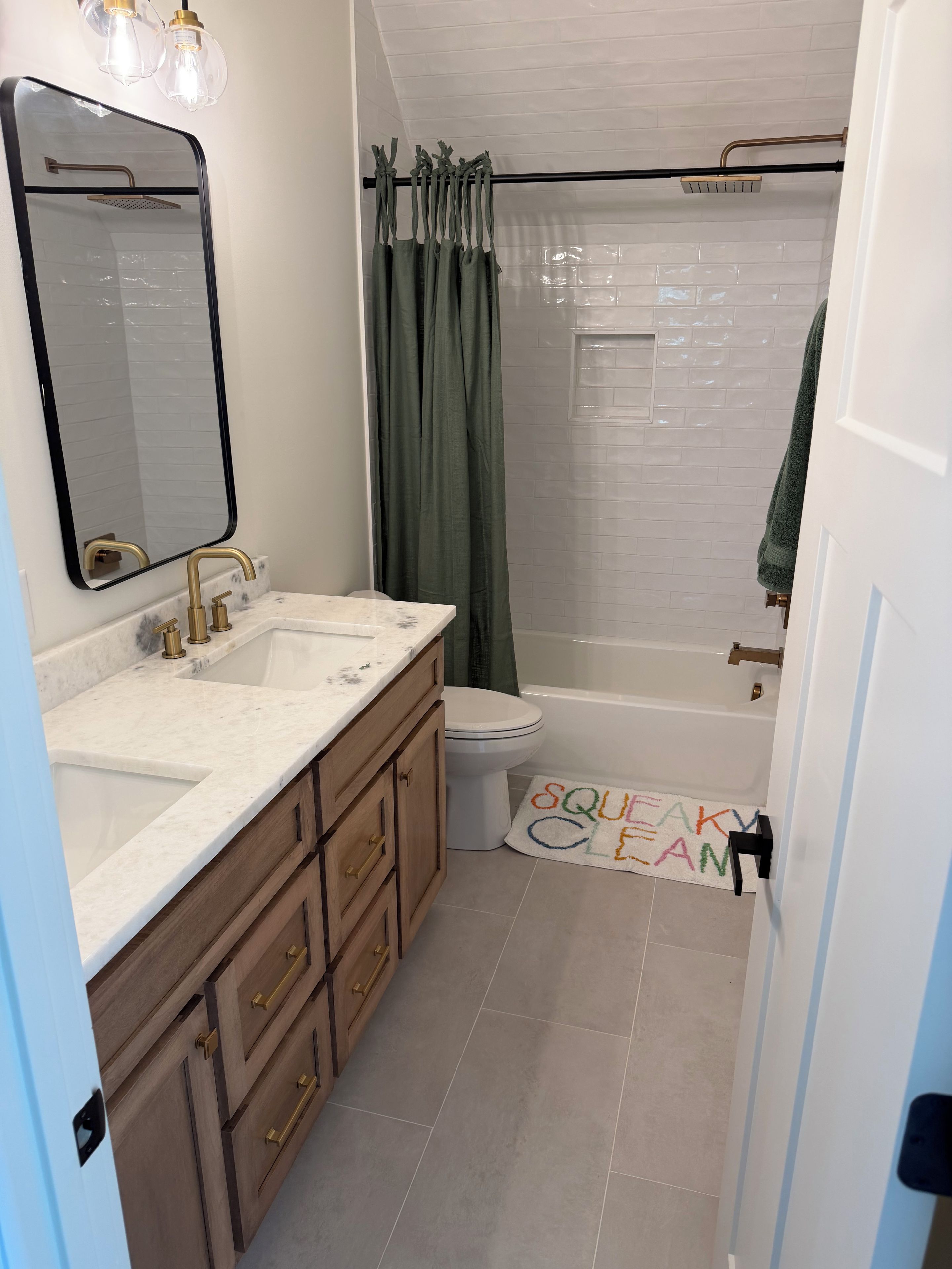 A bathroom with a shower, toilet, and sink.