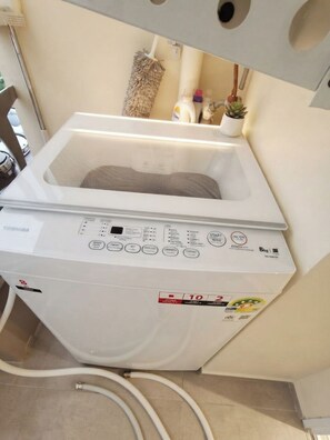 A white washing machine with a control panel, a small window, and a label indicating a weight capacity of 8kg. - Atlantis resort condo Pattaya - One bedroom & living room all included apartment (Muang Pattaya)