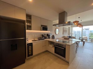 A modern kitchen with a built-in oven, microwave, and stainless steel appliances. - 2BR w/ Rooftop Infinity Pool & Padel Court (Bucerías)