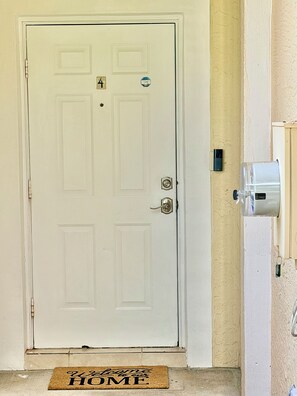 A white door with a doormat that reads 'Welcome to our HOME.' - Entire property 3 Bedroom/2.5 Bath in Boynton Beach (Boynton Beach)