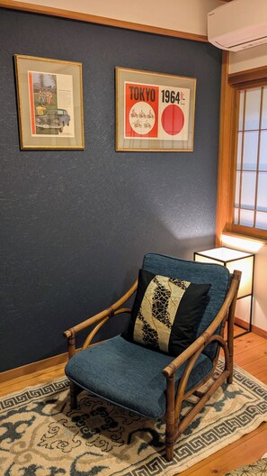 A room with a wooden rocking chair, a framed picture of a car, and a framed Tokyo 1964 poster. - 1880s Kominka - Luxury Renovation - 5 mins from Goryu - Rental Van Available (Hakuba)