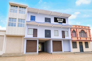A two-story hotel with a signboard indicating it is serviced by OYO.